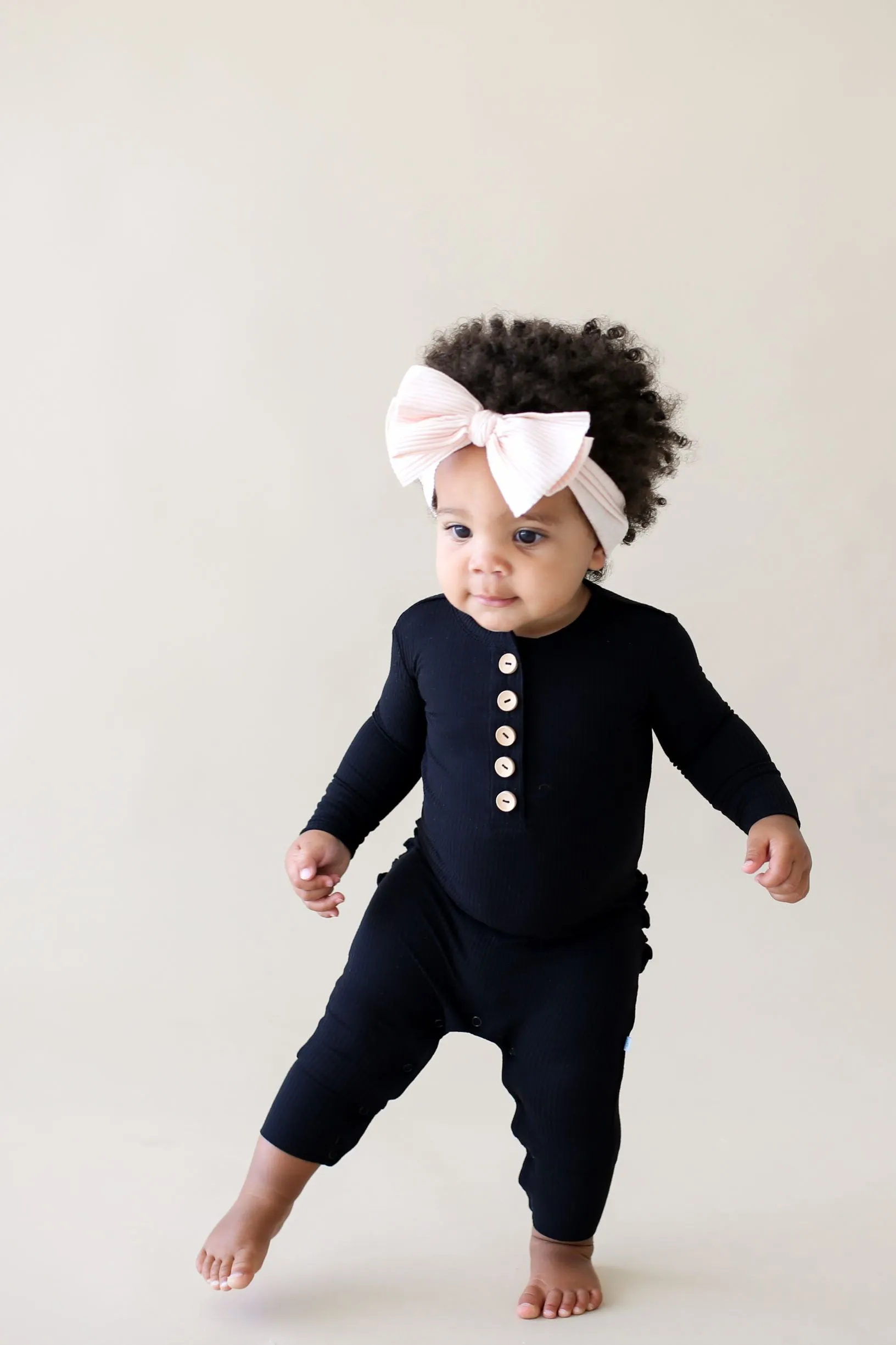 Posh Peanut Solid Ribbed Black L/S Ruffled Henley Romper