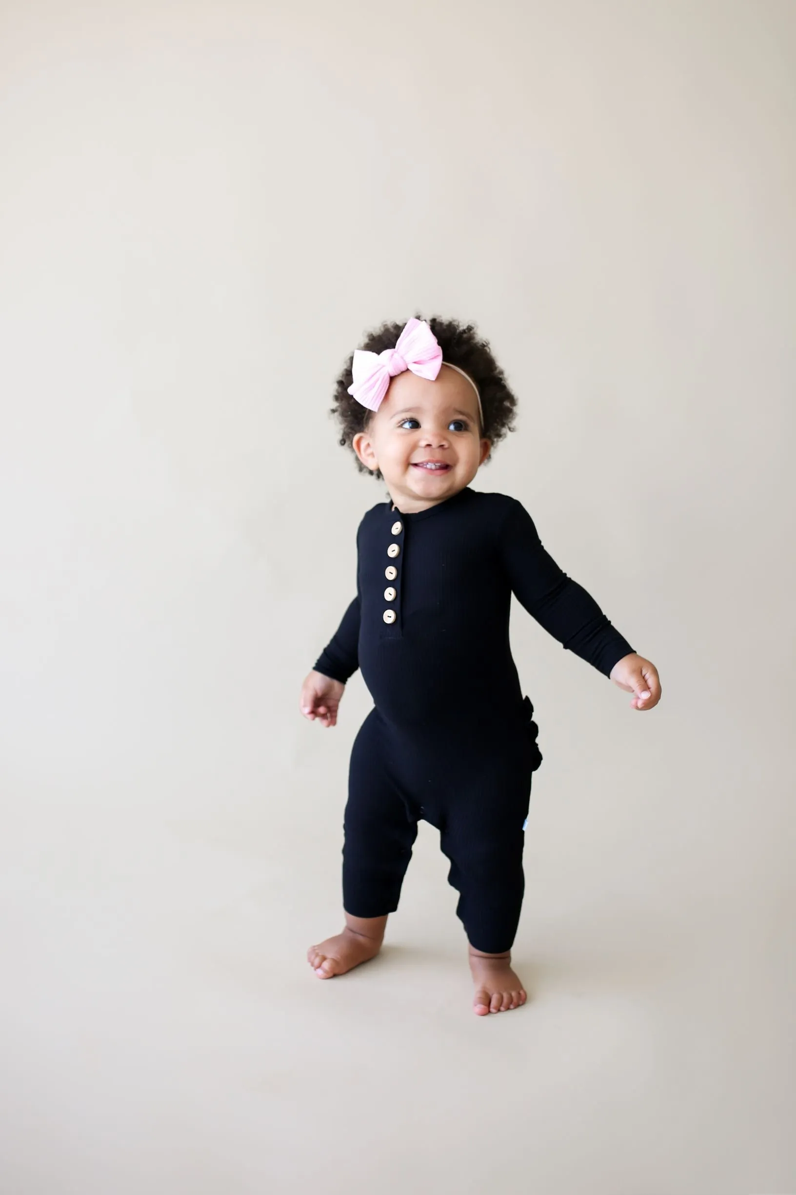 Posh Peanut Solid Ribbed Black L/S Ruffled Henley Romper
