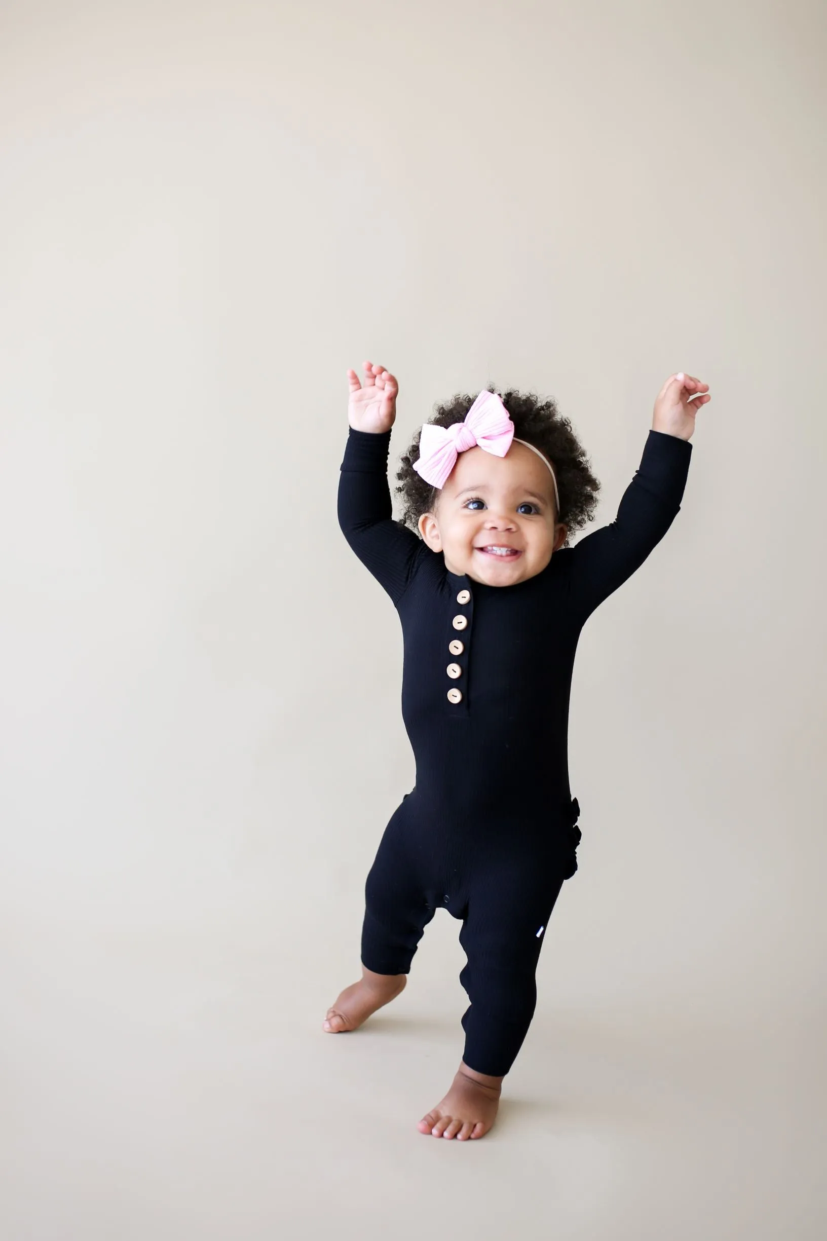 Posh Peanut Solid Ribbed Black L/S Ruffled Henley Romper
